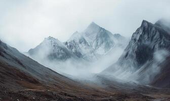 The mountains are covered in snow and the sky is cloudy photo