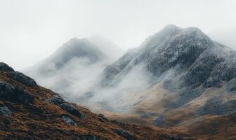 The mountains are covered in snow and the sky is cloudy photo