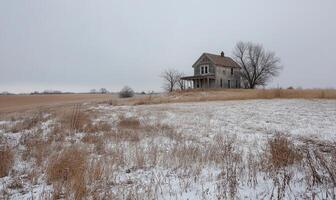 A house is in the middle of a field with snow on the ground photo