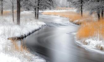 A river with snow on the banks and trees in the background photo