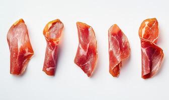 A row of sliced meat on a white background photo