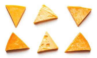 A variety of triangular slices of cheese, each with a different shape and size photo