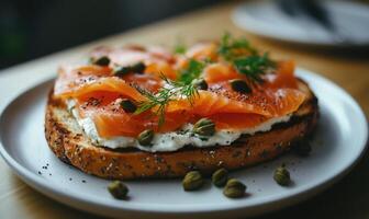A slice of bread with salmon and capers on top photo