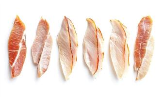 A row of meat slices, including pork, chicken, and fish photo