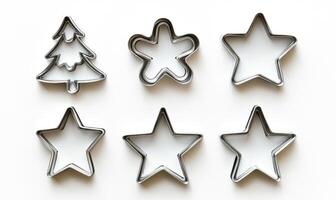 A set of cookie cutters in the shape of stars and a tree photo