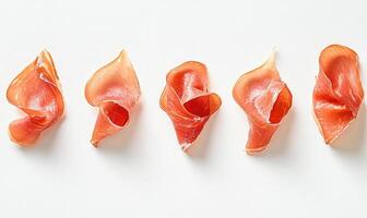 A row of meat slices are arranged on a white background photo