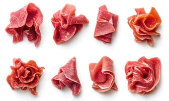 A close up of various pieces of meat, including a slice of pepperoni photo