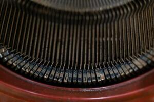A close-up of the keys on a vintage typewriter, showing the intricate detail of the mechanism photo