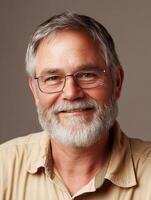 A man with a beard and glasses smiling photo