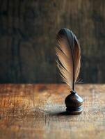 A feather quill on top of a wooden table photo