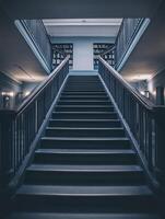 A staircase in a library with bookshelves photo