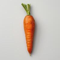 A whole, unpeeled carrot with green stem on a white background. photo