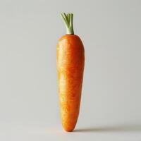 A whole carrot on a white background, showing its stem and roots. photo