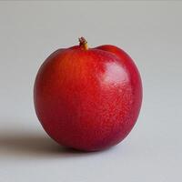 Red apple with a shiny surface and speckles. photo