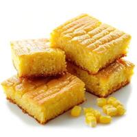 Close-up of delicious yellow cornbread in a loaf shape, topped with corn kernels. photo