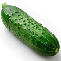 A green cucumber on a white surface with its skin slightly cracked and seeded. photo