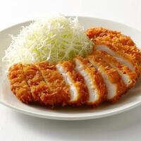 Delicious looking plate of sushi with shredded cabbage and mayonnaise on the side. photo
