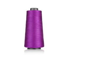 spool of industrial threads pink colors, texture of threads on a white background photo
