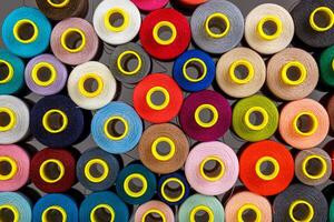 set of multi-colored spools of thread for sewing photo