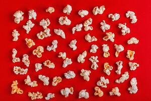box with popcorn on a red background photo