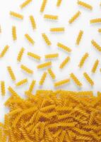 Pasta products in the form of a spiral, texture, on a white background photo