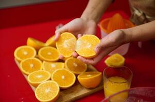 Fresh oranges being cut and prepared for making juice photo