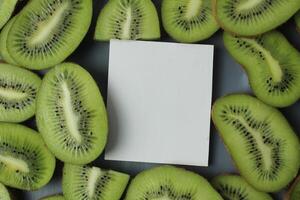 Kiwi mockup slices. A white sheet of paper to write down the mockup next to pieces of green kiwi. Kiwi Food Background photo