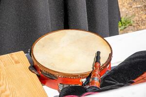 a tambourine and a bagpipe on a table at a folkloric event in Galicia, Spain. Folk music concept background photo