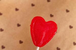Representation of love through a heart-shaped lollipops on a hearts background. photo