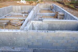 foundation made of cement blocks in a house under construction. Concept of architecture background photo
