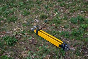 Stake driven into the ground as a topographic base and tripod for the total station. Survey work concept. photo