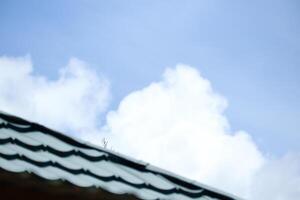 roof with clouds and clear sky in the background photo