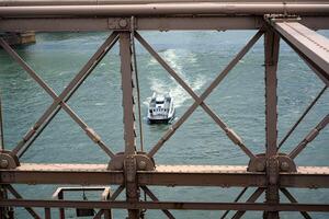 An unusual view through the railing of the Brooklyn Bridge photo