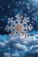 Silver Snowflake Resting on Snow with a Blue Bokeh Background photo