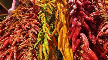 Vibrant dried chili peppers in red, yellow, and green create a colorful market display, perfect for Cinco de Mayo or spice related themes video