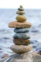 Pyramid of stones. Unstable balance of stone objects. Idyllic state of nature. photo