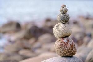 Pyramid of stones. Unstable balance of stone objects. Idyllic state of nature. photo