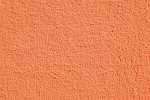 Orange stucco texture. Designer interior background. Abstract architectural surface. photo