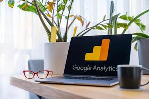 Prague, Czech Republic - September 20, 2024. Laptop with Google Analytics on screen at workspace photo