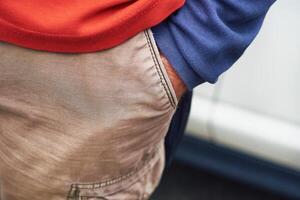 Man's hand in the pocket of beige jeans.Relax, calm photo