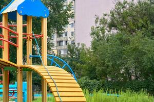 Summer children's playground with painted toy slide in public park photo