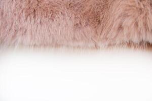 Soft texture of a faux fur coat in warm peach fuzz tones photo