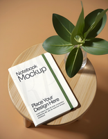 Notebook Mockup on table with leaf psd