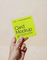 Hand holding a square paper mockup on a simple Background psd