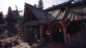 Abandoned rustic cottage in a forest with a glowing forge at dusk video