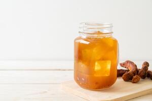 Delicious sweet drink tamarind juice and ice cube photo