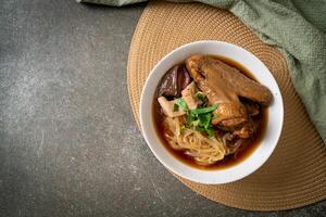 Braised duck noodles with brown soup photo