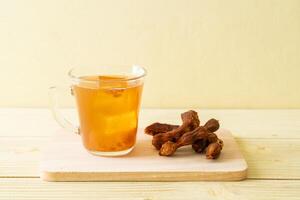 Delicious sweet drink tamarind juice and ice cube photo