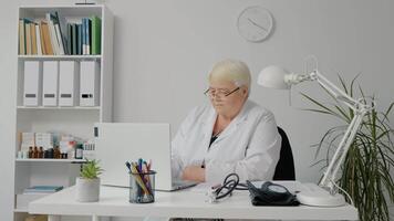 Medical worker saving patients history data in computer. video