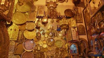 Street shot of carved cooper lamps hanging on the walls along with mirrors and icons. video